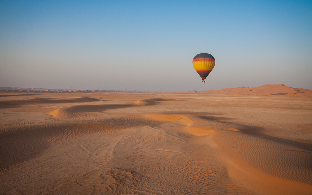 Hot Air Balloon floating over the desert sand &copy; Joseph Borg / Shutterstock.com